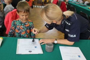 policjantka przeprowadza pokaz ujawniania odbitek linii papilarnych