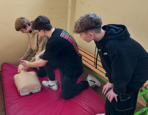 Uczniowie wykonują zadania z zakresu udzielania pierwszej pomocy.
