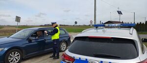 Policjantka mierzy prędkość pojazdów.